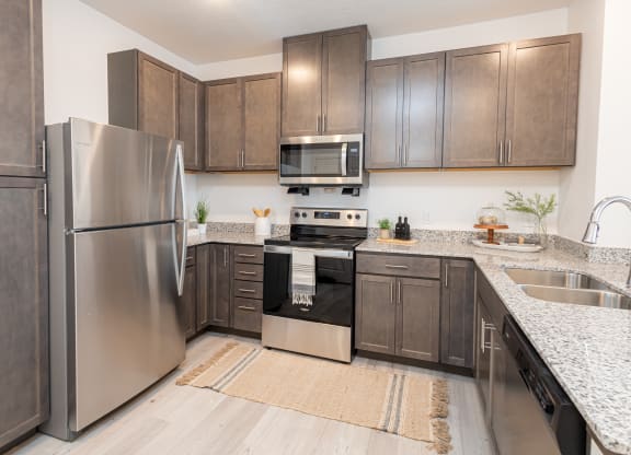 a kitchen with stainless steel appliances and wooden cabinets