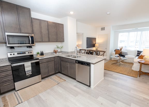 an open kitchen and living room with a couch and a table