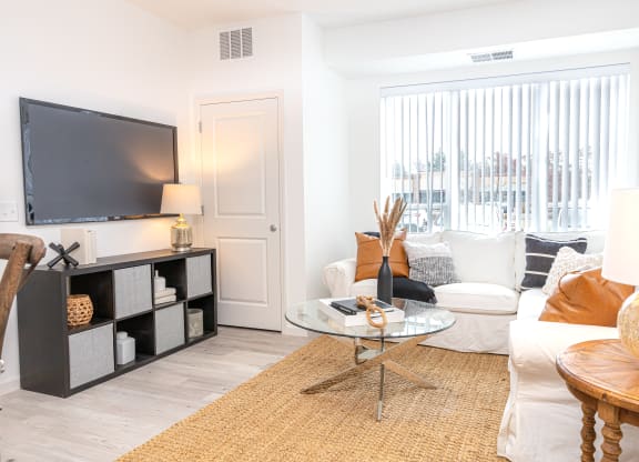 a living room with a couch and a table and a television