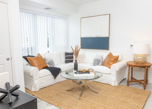 a living room with a white couch and a table