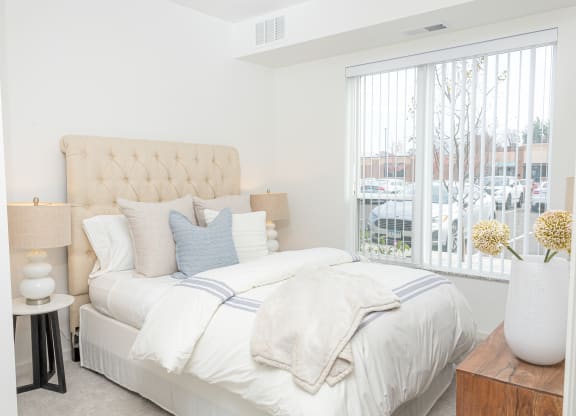 a bedroom with a large bed and a large window