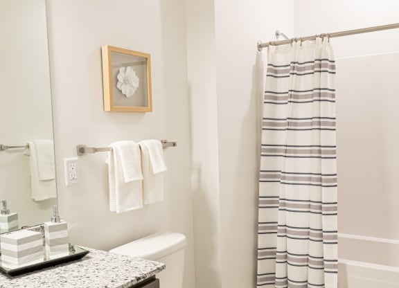 a small bathroom with a toilet and a shower and a sink