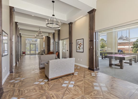 the estates at tangle wood living room with pool table at The Winslow 62+ Apartments, West St Paul, MN