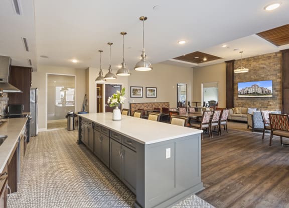 a large kitchen with a center island and a dining room at The Winslow 62+ Apartments, West St Paul