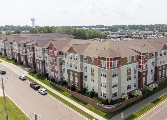an aerial view of an apartment building on a city street at The Winslow 62+ Apartments, Minnesota, 55118
