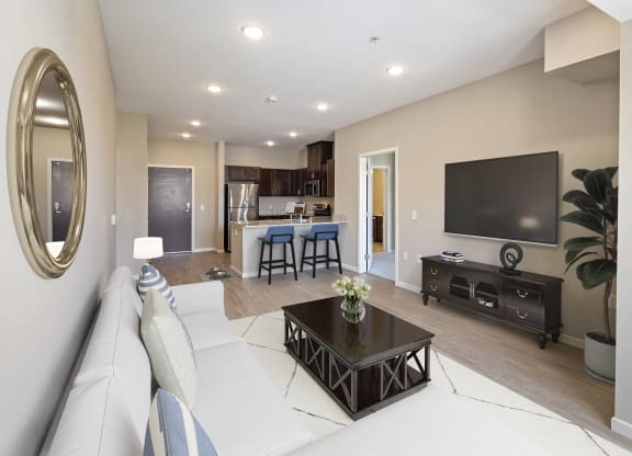 a living room with a couch and a television at The Winslow 62+ Apartments, Minnesota