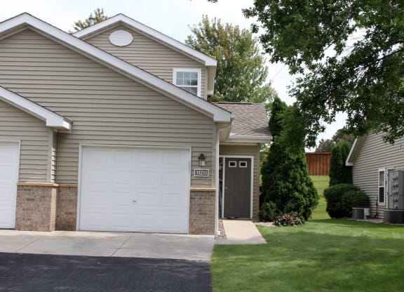 exterior of 1 bedroom single car garage townhome and private entry