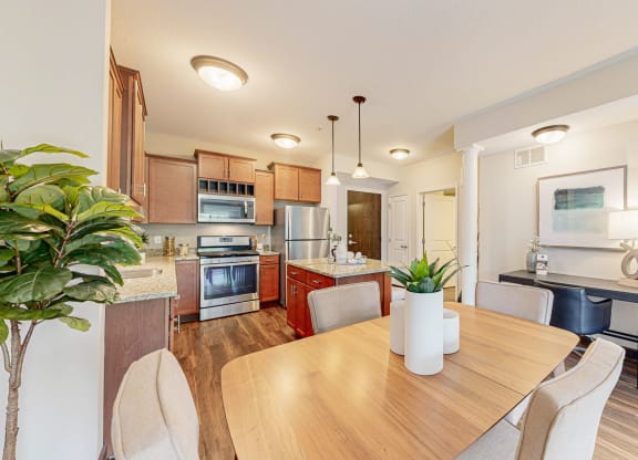 a dining room and kitchen with a table and chairs