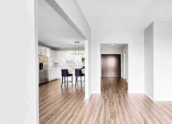 A long hallway with a dining area at the end.