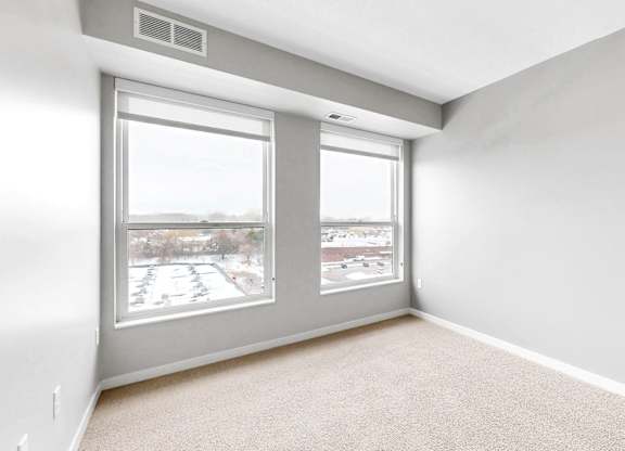 A room with a large window and a sliding glass door.