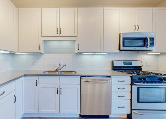 beautiful kitchen with white cabinetry and countertops
