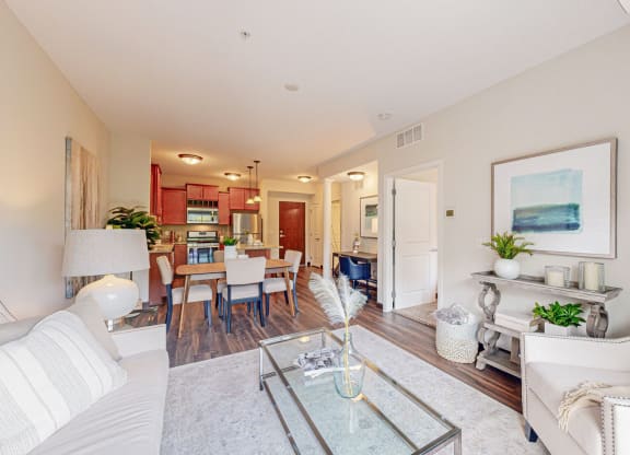 a living room with a couch and a glass table