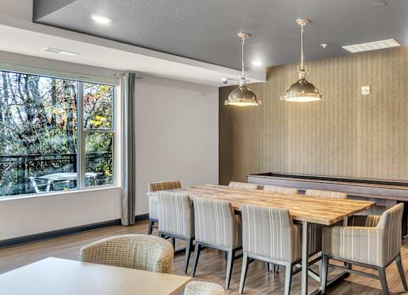 A conference room with a long table and chairs.