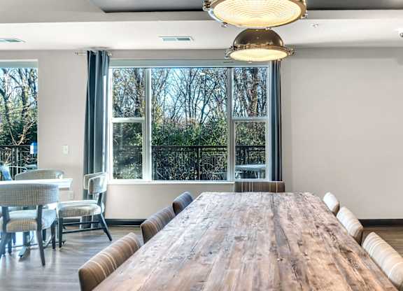 A conference room with a long wooden table and chairs.