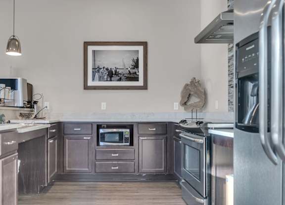 A kitchen with stainless steel appliances and wooden cabinets.