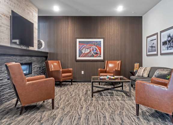 A living room with a fireplace and a painting on the wall.