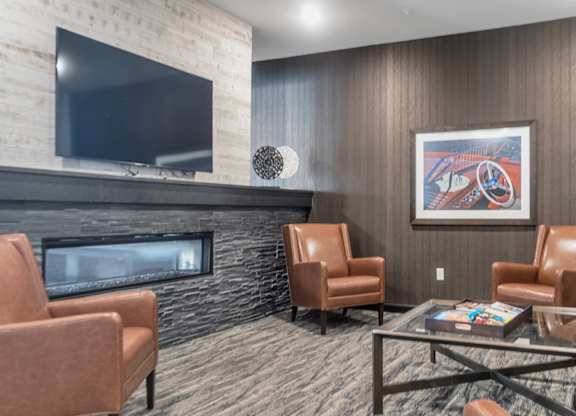 A living room with a fireplace and a painting on the wall.