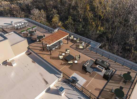 A rooftop patio with a table and chairs.