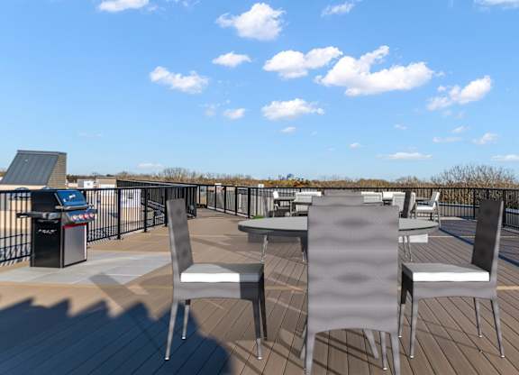 A deck with chairs and a table is set up on a sunny day.
