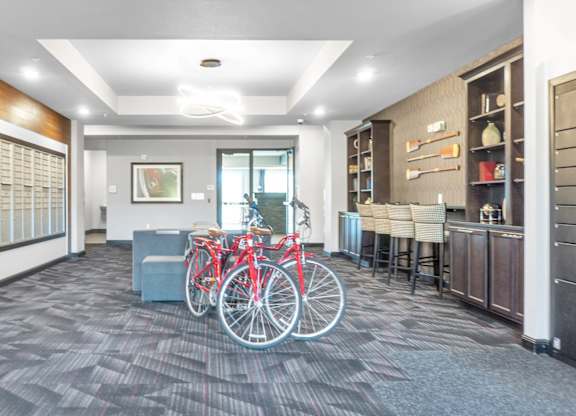 A room with a bicycle and a bench.