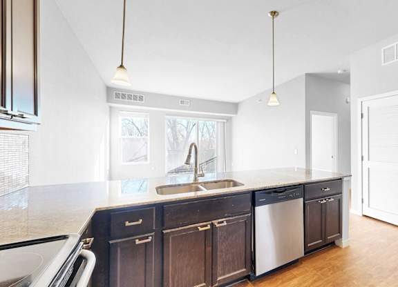 A kitchen with a sink and a window.