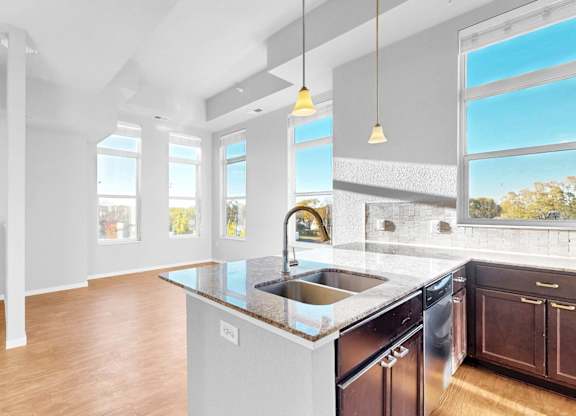 A modern kitchen with a large island and stainless steel appliances.
