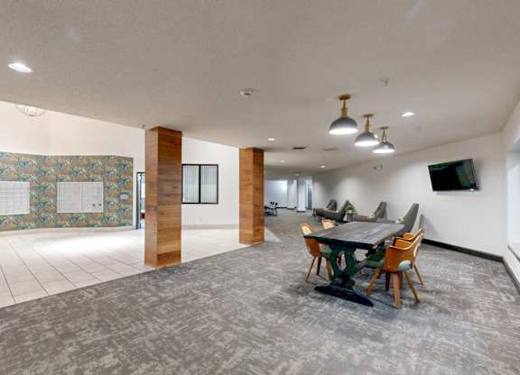 A conference room with a long table and chairs.
