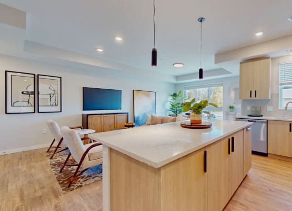 a kitchen with a large island and a living room