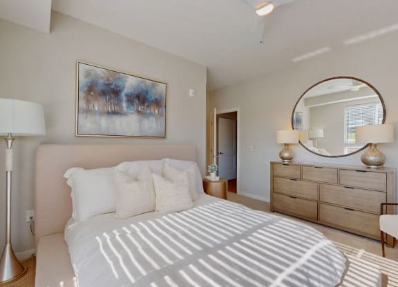 a white bedroom with a large bed and a window