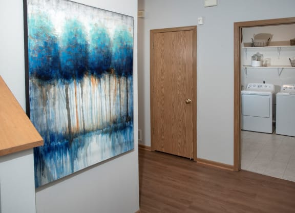 Laundry room with full size washer and dryer and shelving