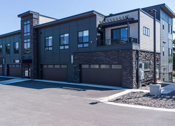 a large building with a driveway and garage doors
