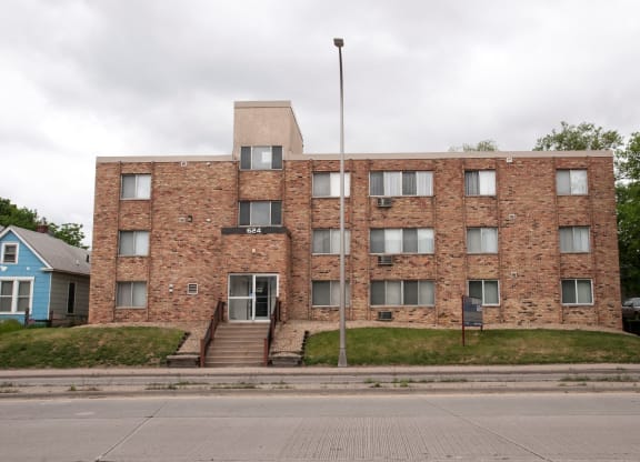 a large brick building with a flagpole in front of it