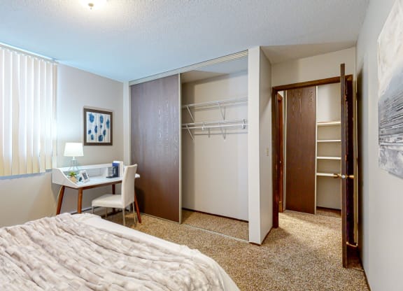 a bedroom with a large bed and a closet