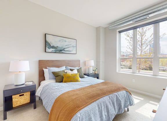 a bedroom with a large window and a large bed