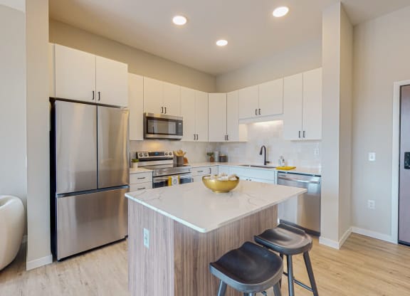 a kitchen with white cabinets and a large yellow bowl on the counter