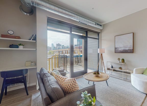a living room with a sliding glass door and a balcony