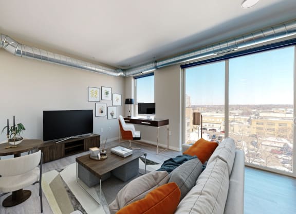 a living room with a large window and a view of a city