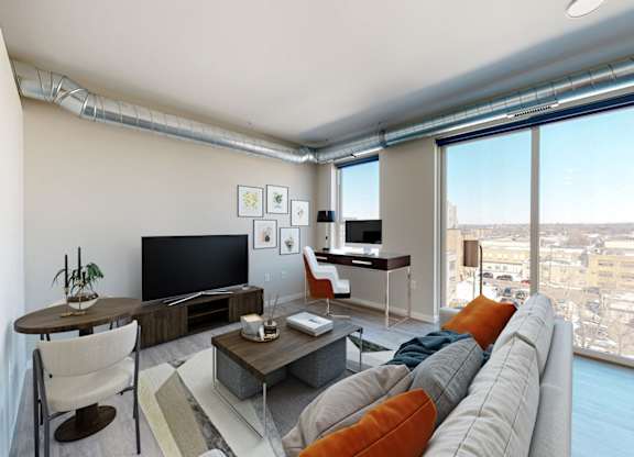 a living room with a large window and a view of a city