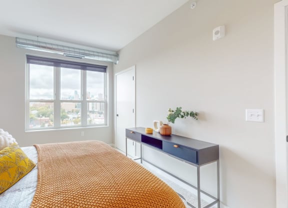 a bedroom with a bed and a desk