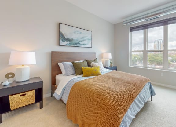 a bedroom with a bed and two windows