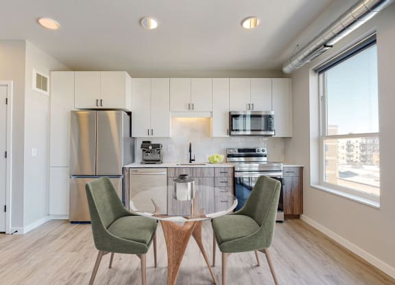 a kitchen and dining room with a table and chairs