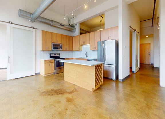 a large kitchen with wood cabinets and stainless steel appliances