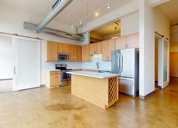 a kitchen with wood cabinets and stainless steel appliances