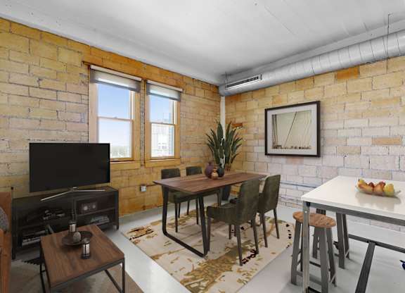A living room with a brick wall and a flat screen TV.