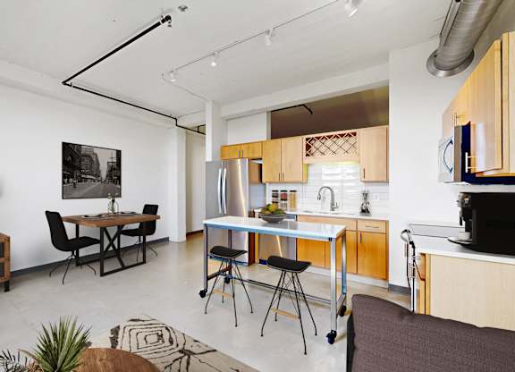 A modern kitchen with a dining table and chairs.