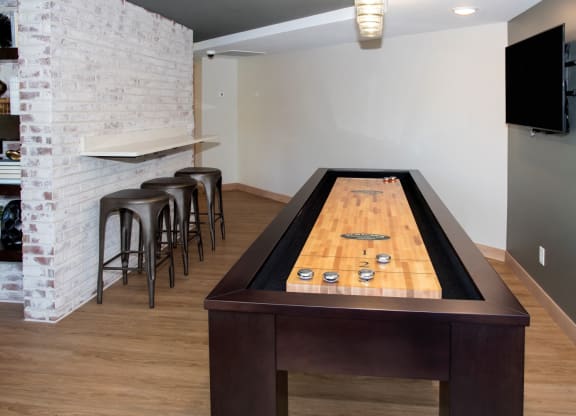 Shuffleboard table and tv at Aspenwoods Apartments, Eagan
