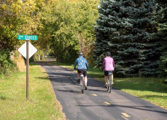 people biking on trails at Urban Park I and II Apartments, St Louis Park, MN