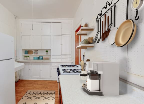 a kitchen with white cabinets and a white refrigerator