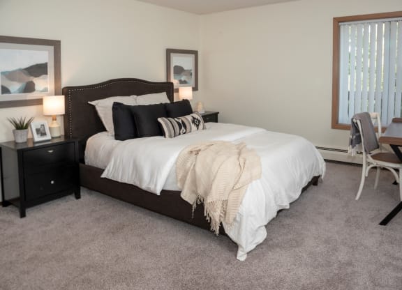 a bedroom with a bed and a desk with a chair