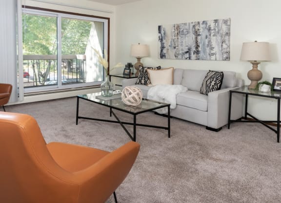 a living room with a couch and a table and a window